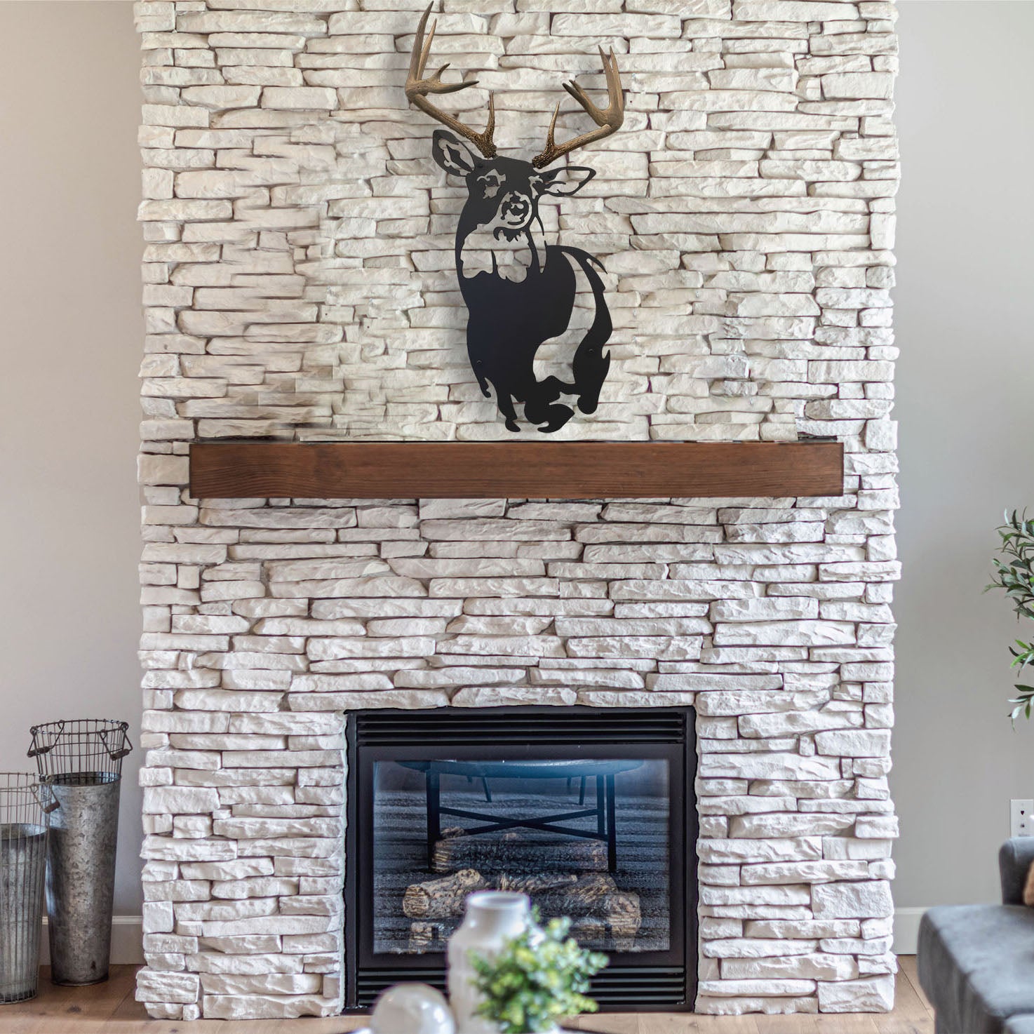 A banner image featuring an anlter & metal wall decor by Dekor Nature above a fireplace