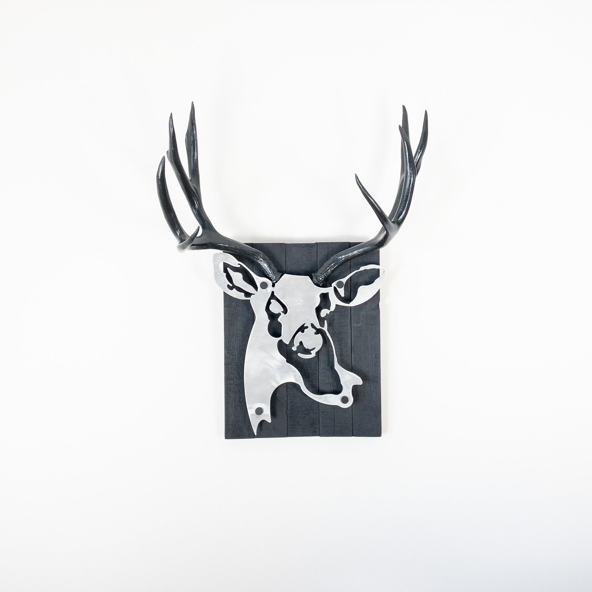 A metal wall decor made from real ethically sourced  Mule Deer antlers mounted on a metal head