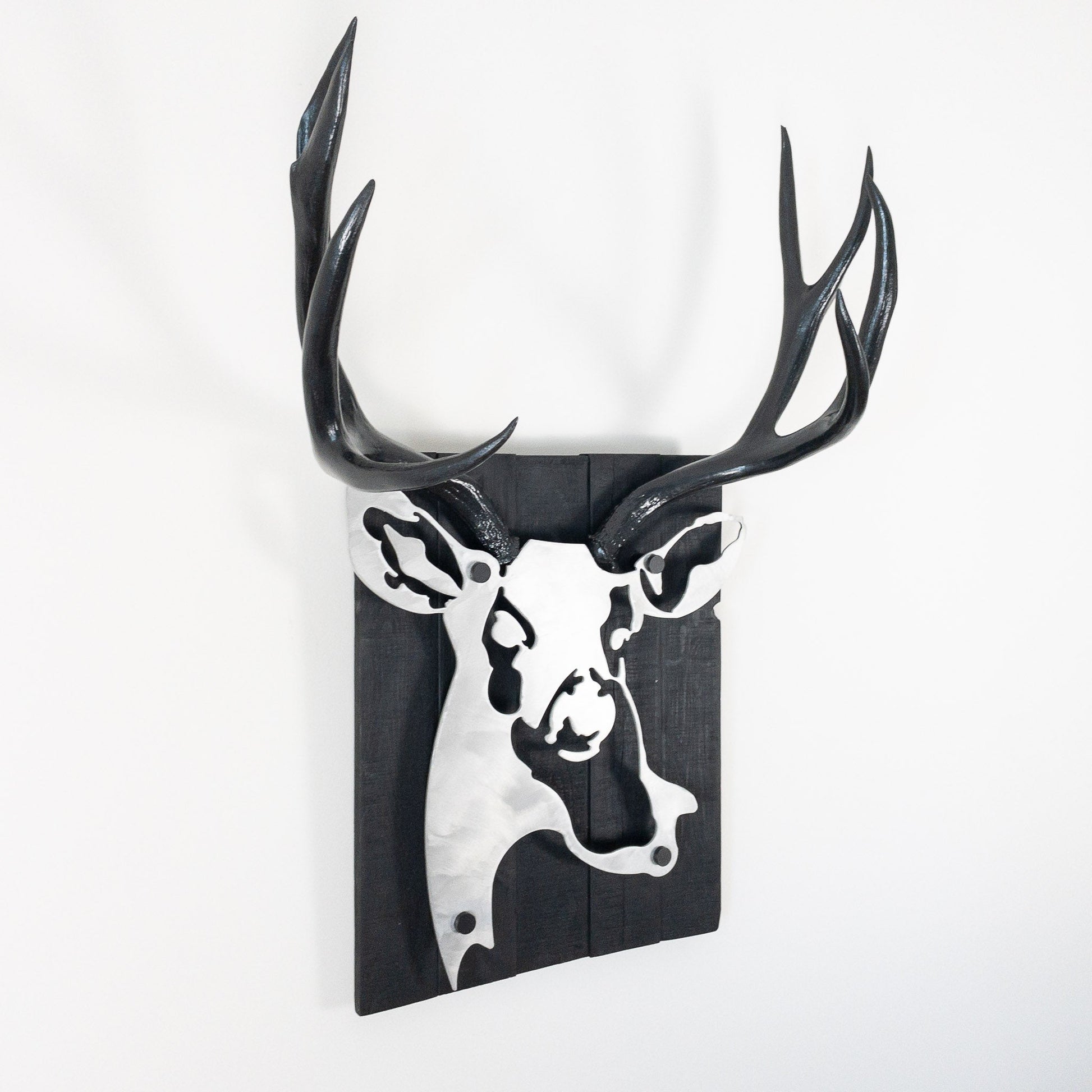 A metal wall decor made from real ethically sourced  Mule Deer antlers mounted on a metal head