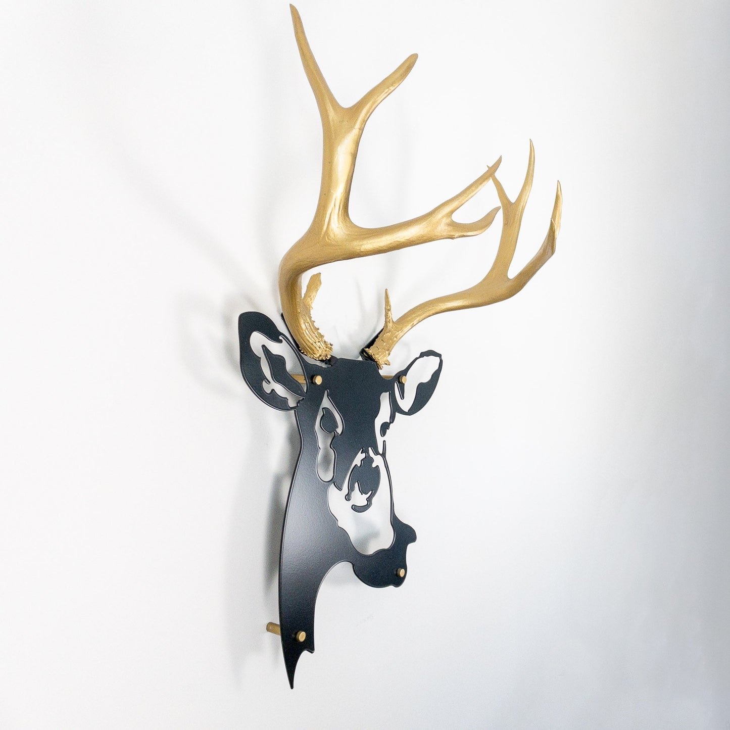 A metal wall decor made from real ethically sourced  Mule Deer antlers mounted on a metal head