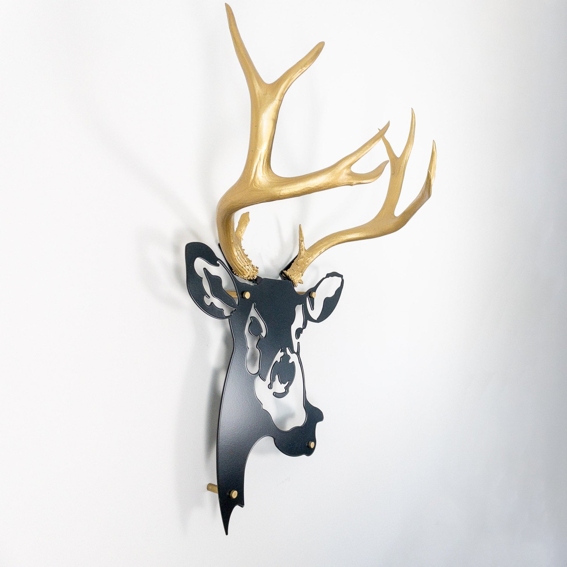 A metal wall decor made from real ethically sourced  Mule Deer antlers mounted on a metal head