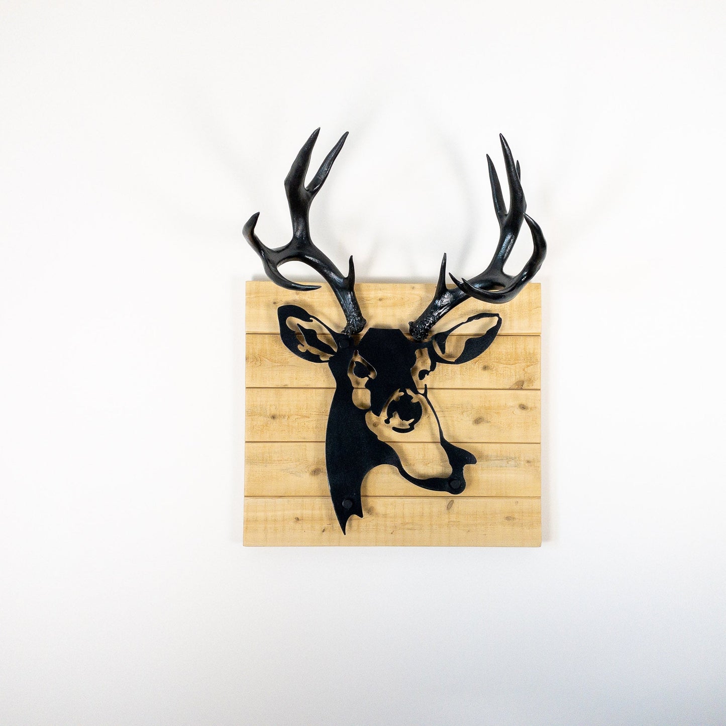 A metal wall decor made from real ethically sourced  Mule Deer antlers mounted on a metal head