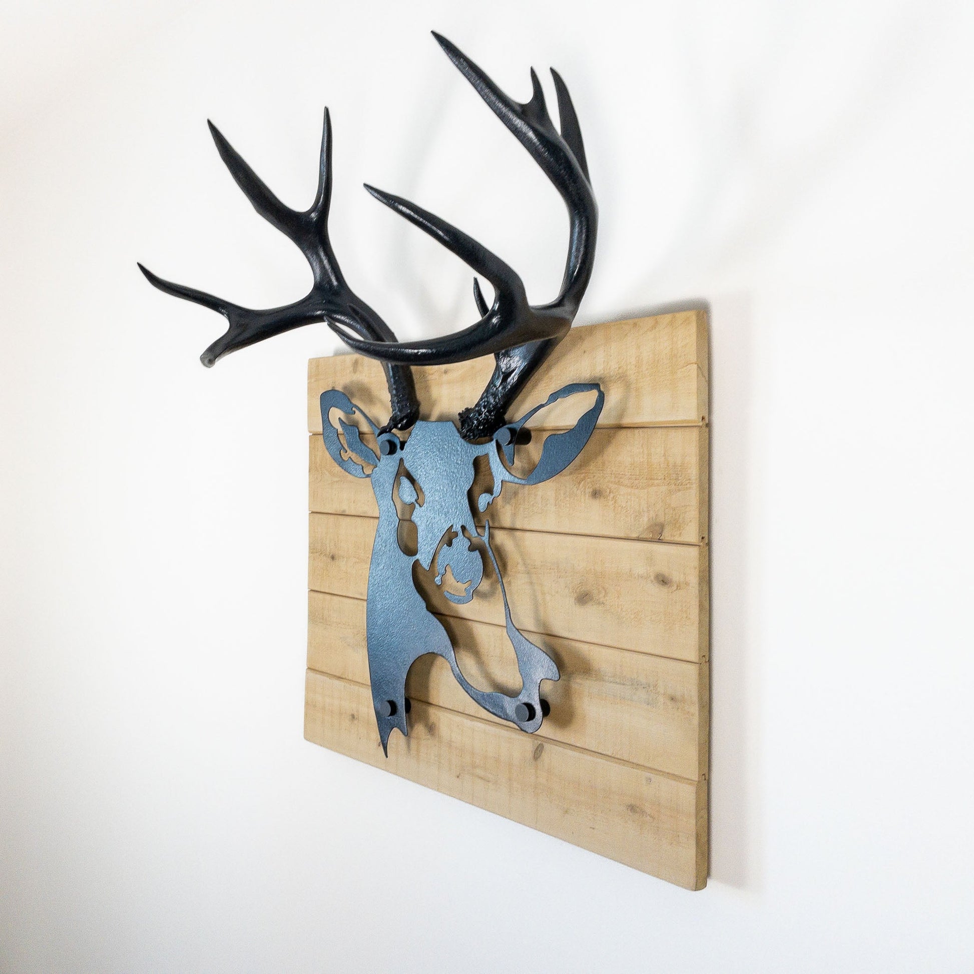 A metal wall decor made from real ethically sourced  Mule Deer antlers mounted on a metal head