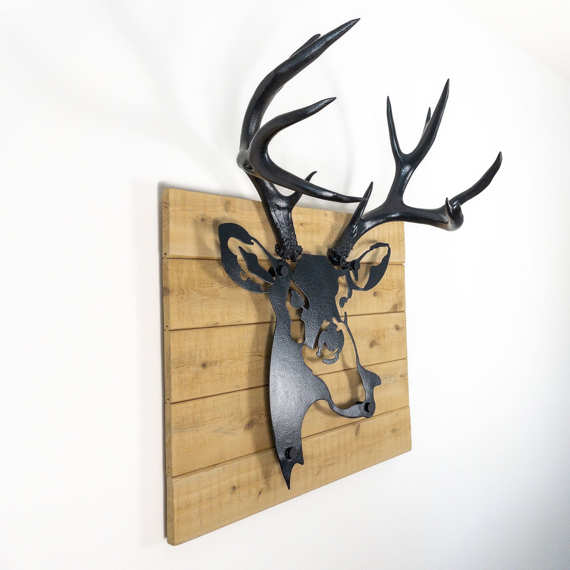 A metal wall decor made from real ethically sourced  Mule Deer antlers mounted on a metal head