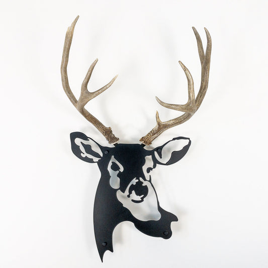 A metal wall decor made from real shed  Mule Deer antlers mounted on a metal head
