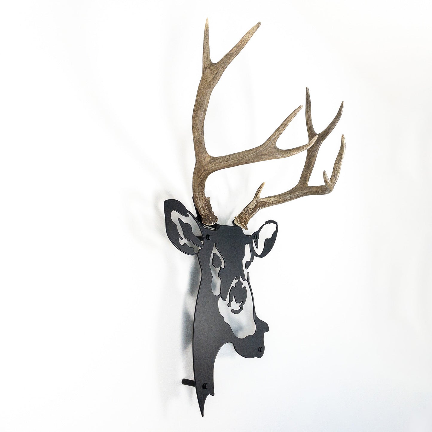 A metal wall decor made from real shed  Mule Deer antlers mounted on a metal head