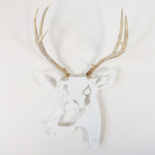 A metal wall decor made from real shed  Mule Deer antlers mounted on a metal head