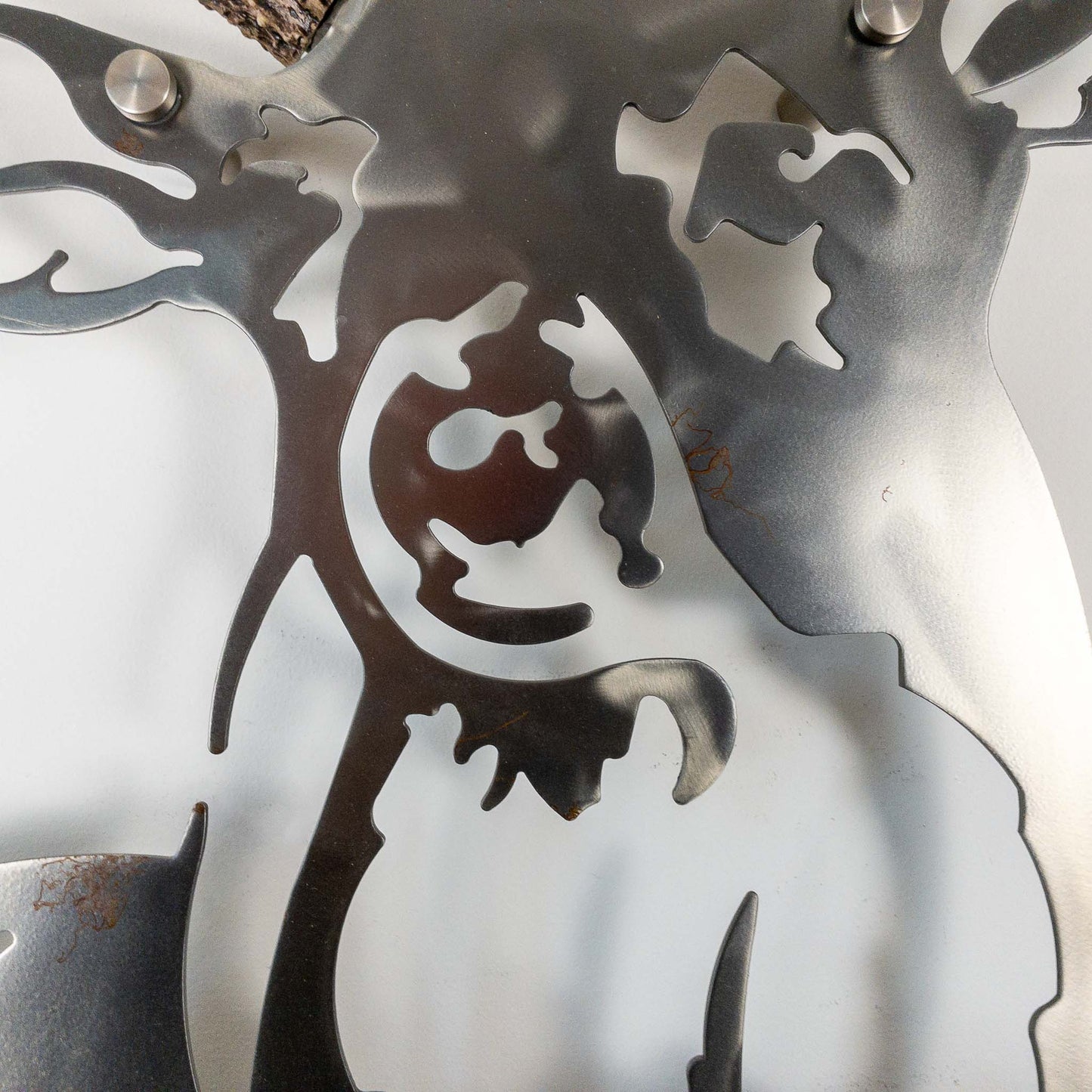 A metal wall decor made from real ethically sourced  White-Tailed Deer antlers mounted on a metal head