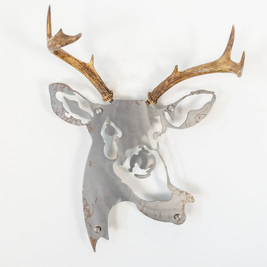 A metal wall decor made from real ethically sourced  White-Tailed Deer antlers mounted on a metal head