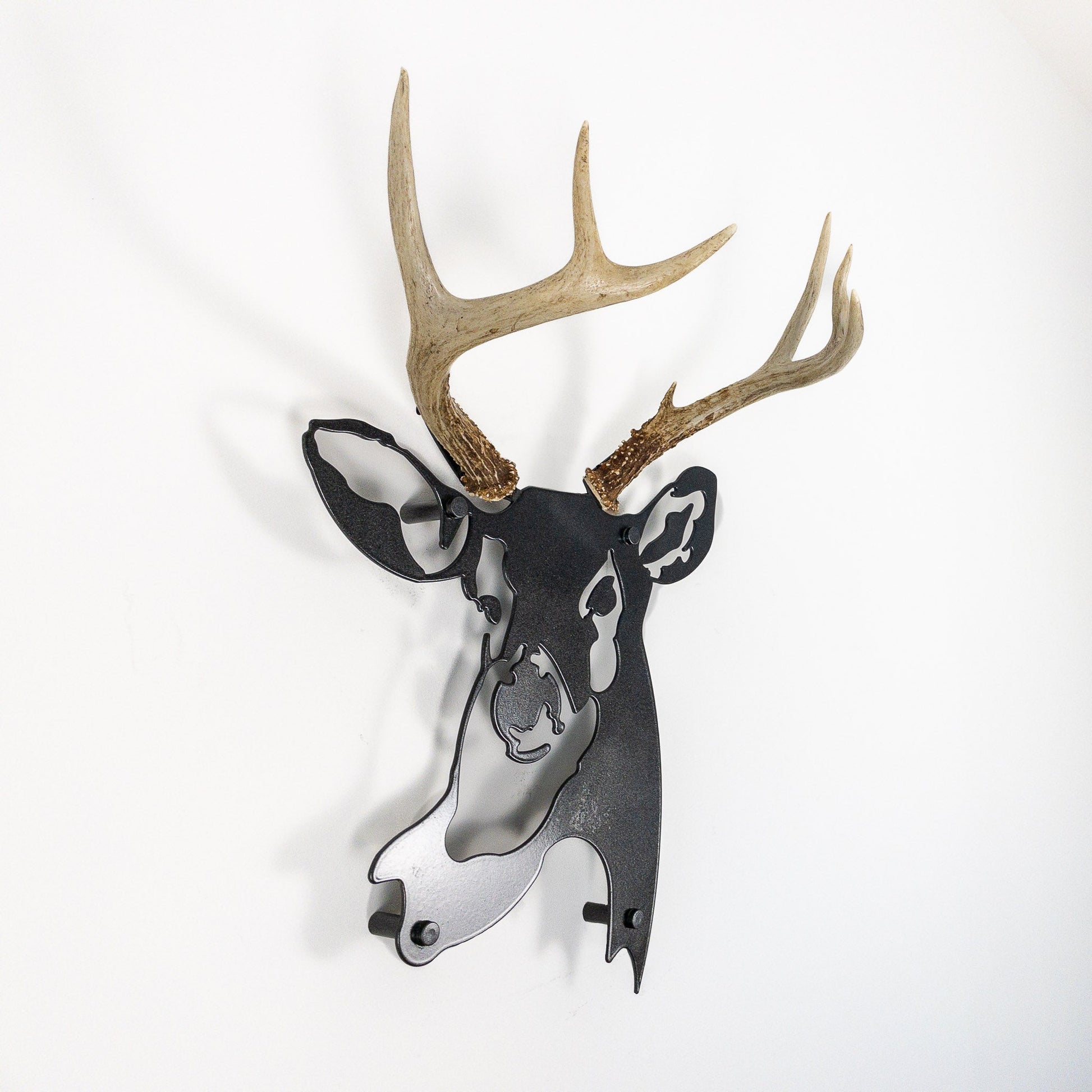 A metal wall decor made from real ethically sourced  White-Tailed Deer antlers mounted on a metal head