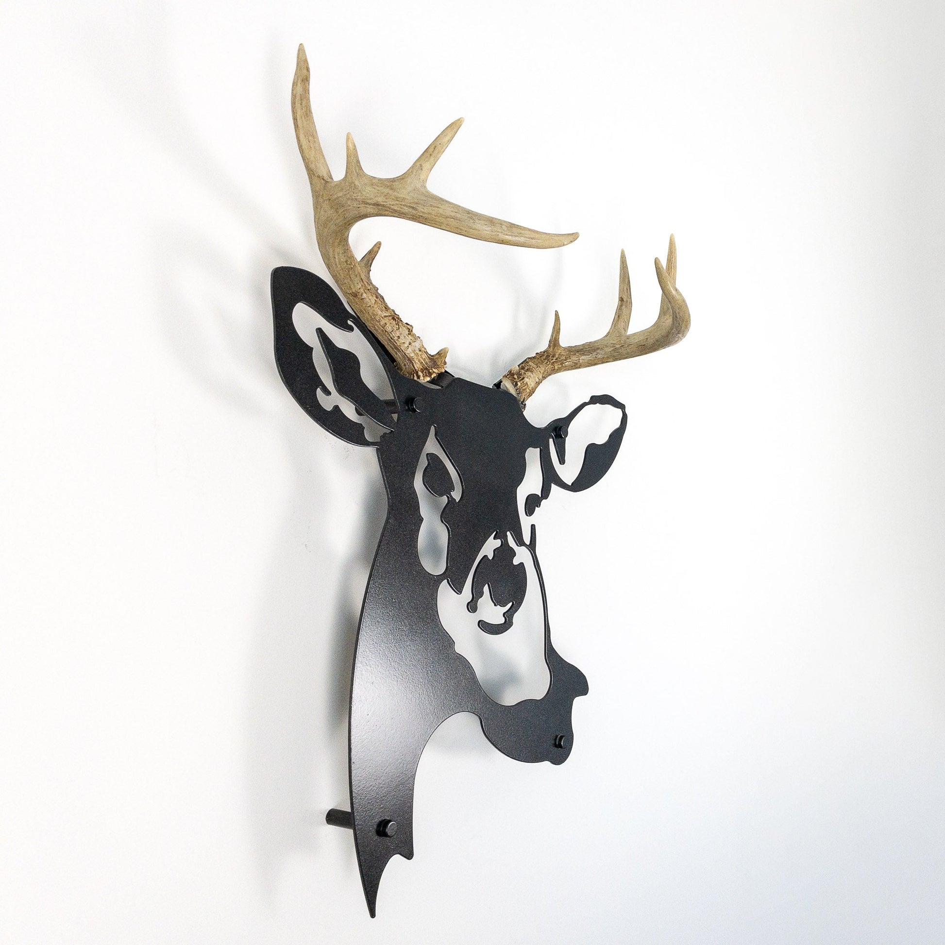 A metal wall decor made from real ethically sourced  White-Tailed Deer antlers mounted on a metal head