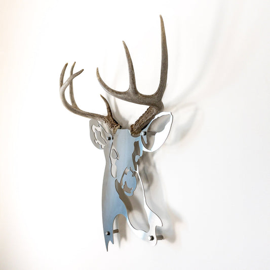 A metal wall decor made from real shed  White-Tailed Deer antlers mounted on a metal head