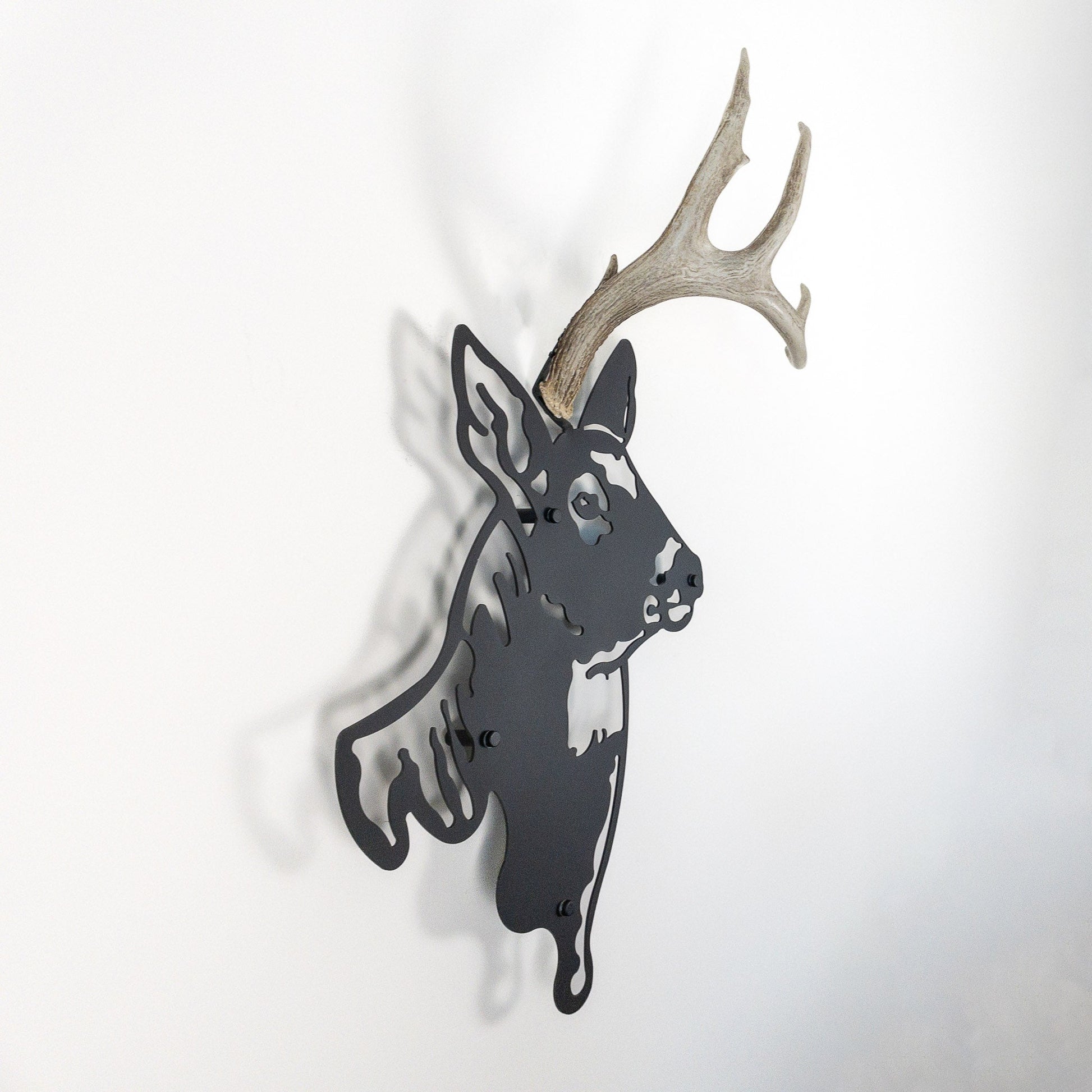 A metal wall decor made from real shed  White-Tailed Deer antlers mounted on a metal head