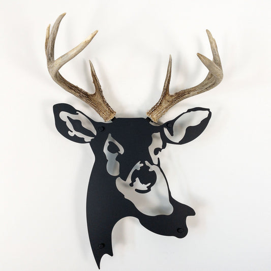 A metal wall decor made from real shed  White-Tailed Deer antlers mounted on a metal head