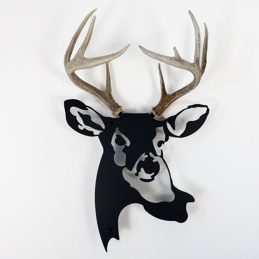 A metal wall decor made from real shed  White-Tailed Deer antlers mounted on a metal head