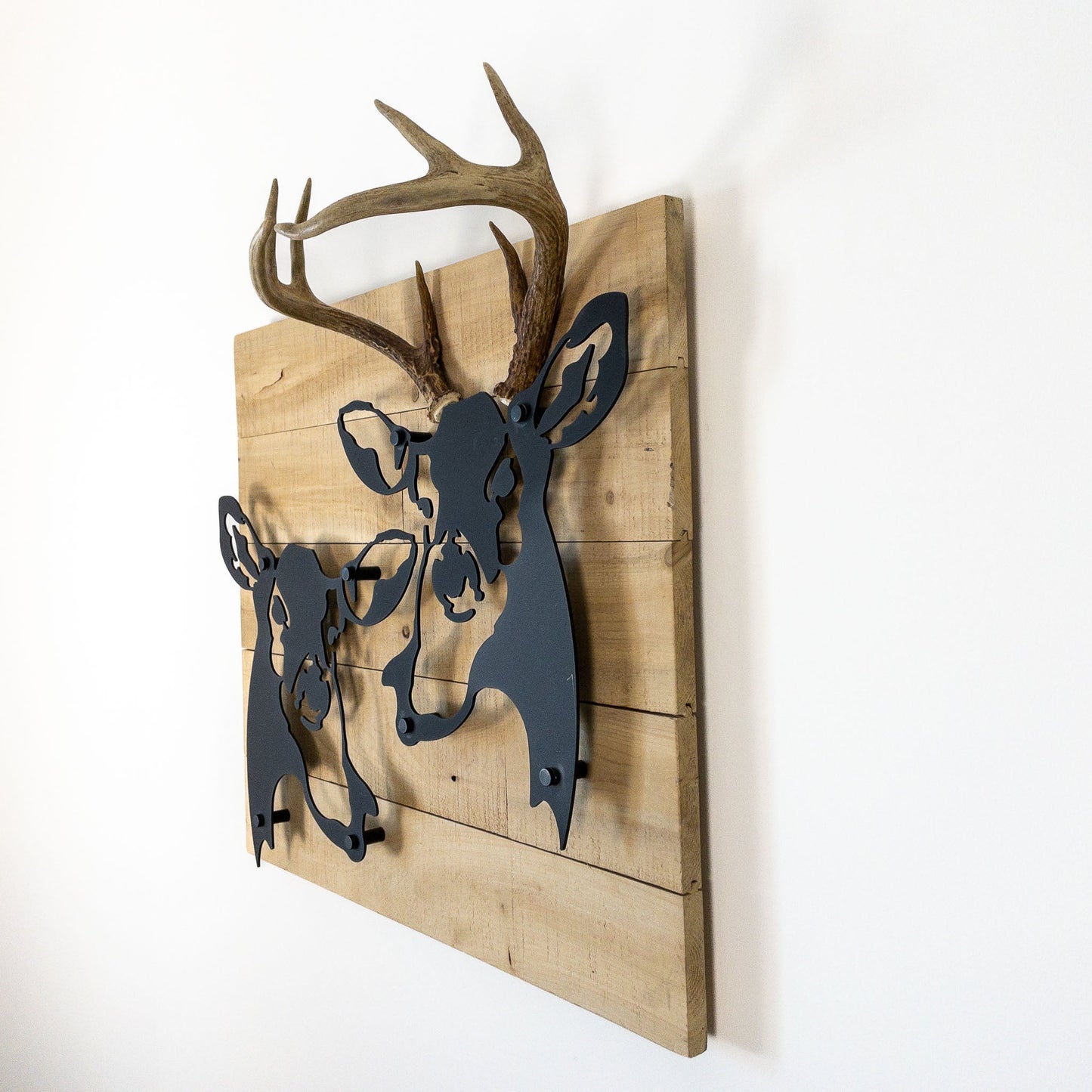 A metal wall decor made from real ethically sourced  White-Tailed Deer antlers mounted on a metal head