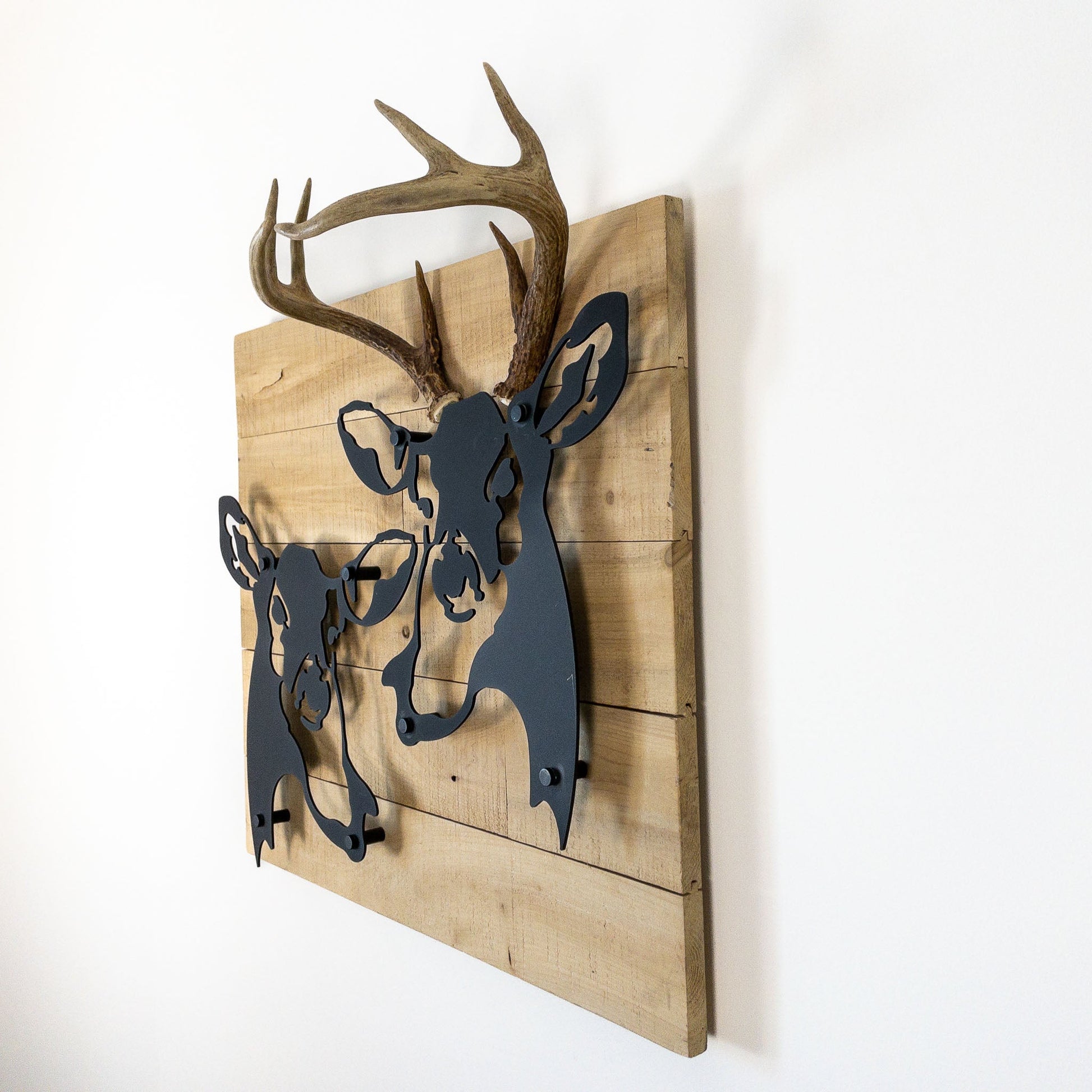 A metal wall decor made from real ethically sourced  White-Tailed Deer antlers mounted on a metal head