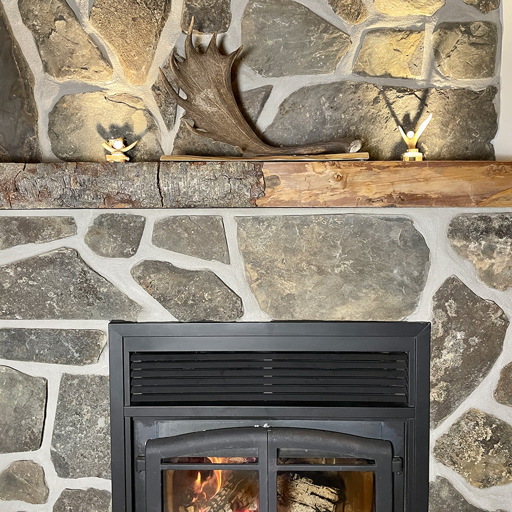 A banner image showing a fallow deer antler and two inukshuks made from deer antlers above a fireplace